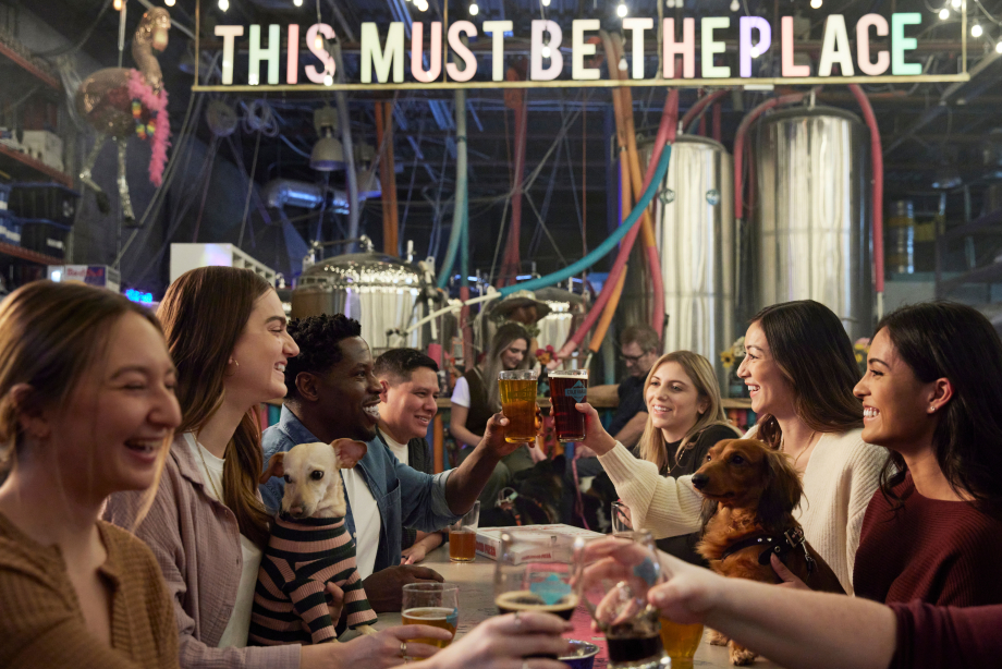 Group of friends cheers-ing beers at Cold Garden Brewery
