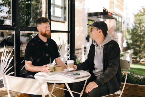 Two friends enjoying coffee and conversation at NHBR Coffee in Calgary