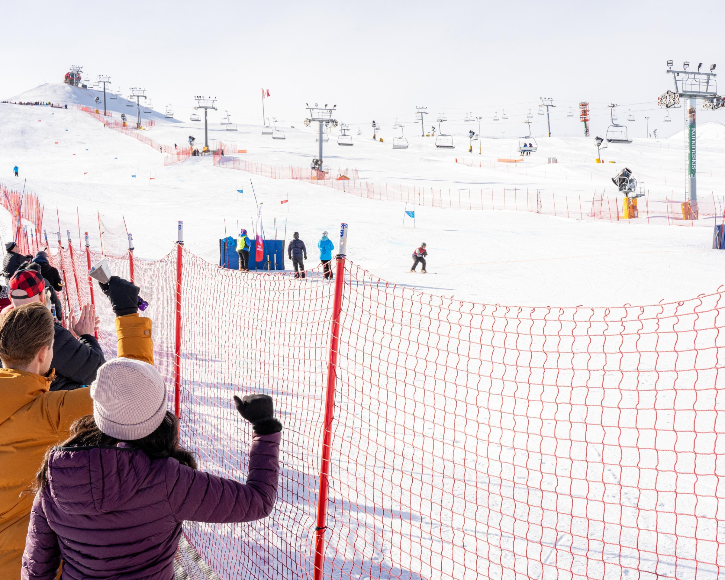 Spectators cheering on a ski competition