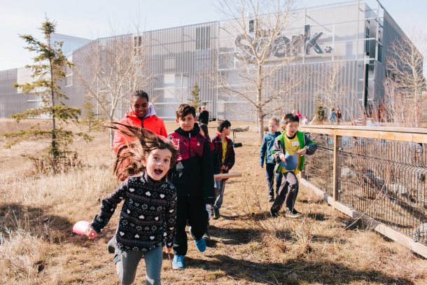 Kids playing in the playground in front of TELUS Spark in Calgary